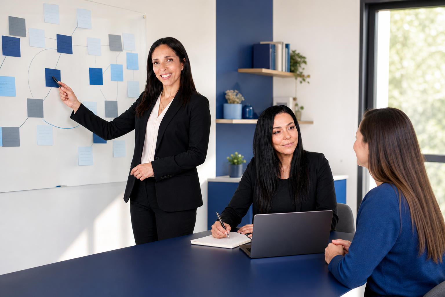 Les deux ambassadrices LDAi préparent un plan de reconversion : l’une analyse un tableau de compétences sur ordinateur, l’autre échange avec une participante autour de fiches métie